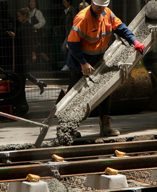 Worker guiding a concrete pour